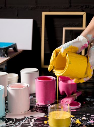 artist-mixing-paint-from-cans_23-2148591293