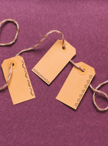 tied-tags-with-purple-background_23-2148370122