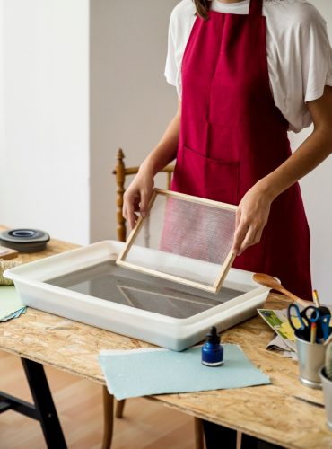 woman-holding-mold-tray-filled-with-paper-pulp_23-2147845508