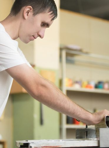 young-man-screen-printing_1163-2777